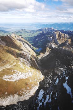 A stunning aerial view of the Swiss Alps in Hundwil, showcasing towering peaks and lush valleys.