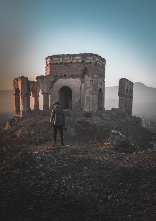 Man Standing on Ruins Digital Wallpaper