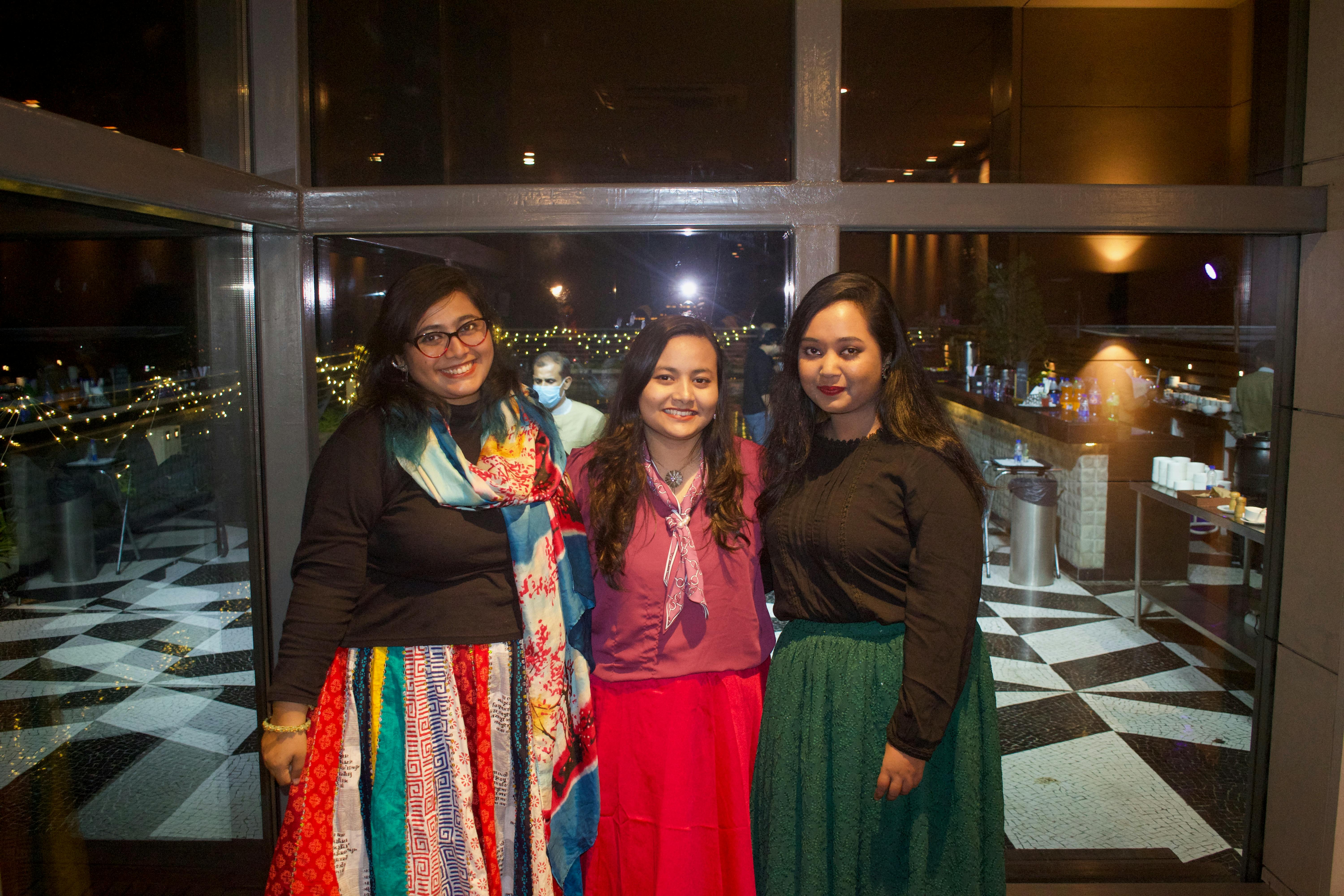 A person holding a video game controller with neon lights in the background.
