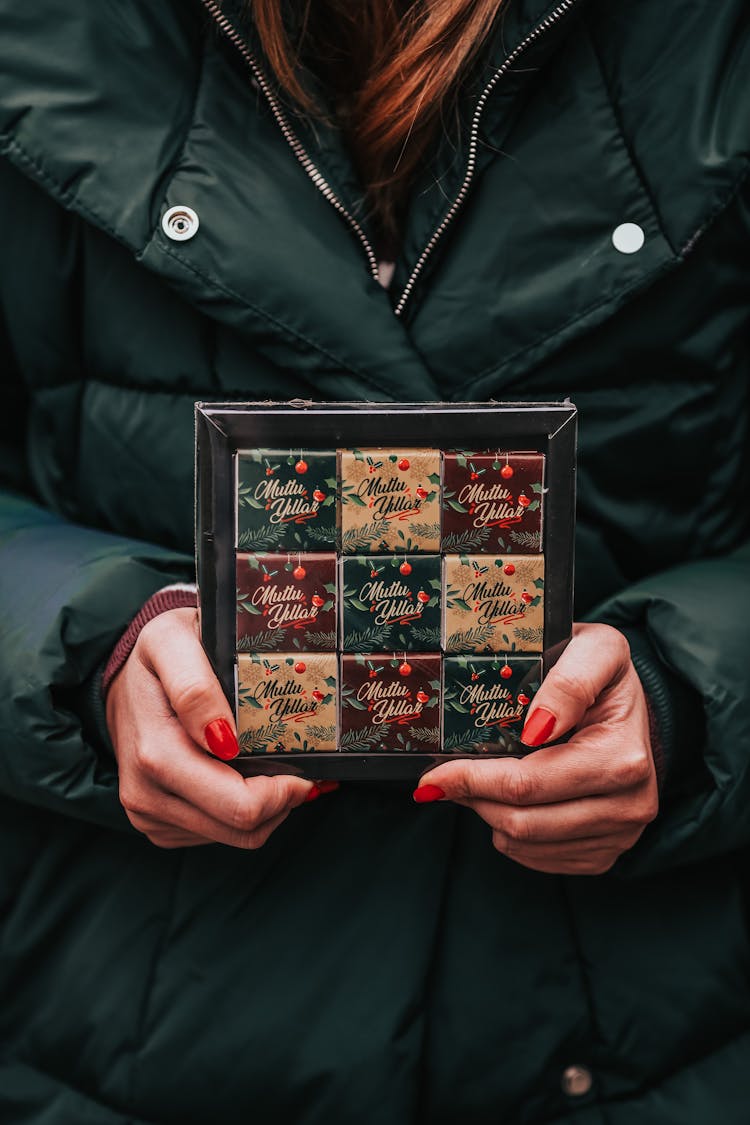 Close-up Of Woman Holding Box Of Chocolates