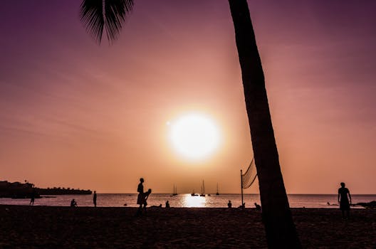 A scenic view of people silhouetted at sunset on Tarrafal Beach, Cape Verde.