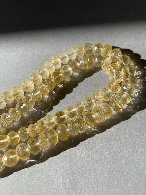 Close Up Photo of Two Strands of Citrine Beads