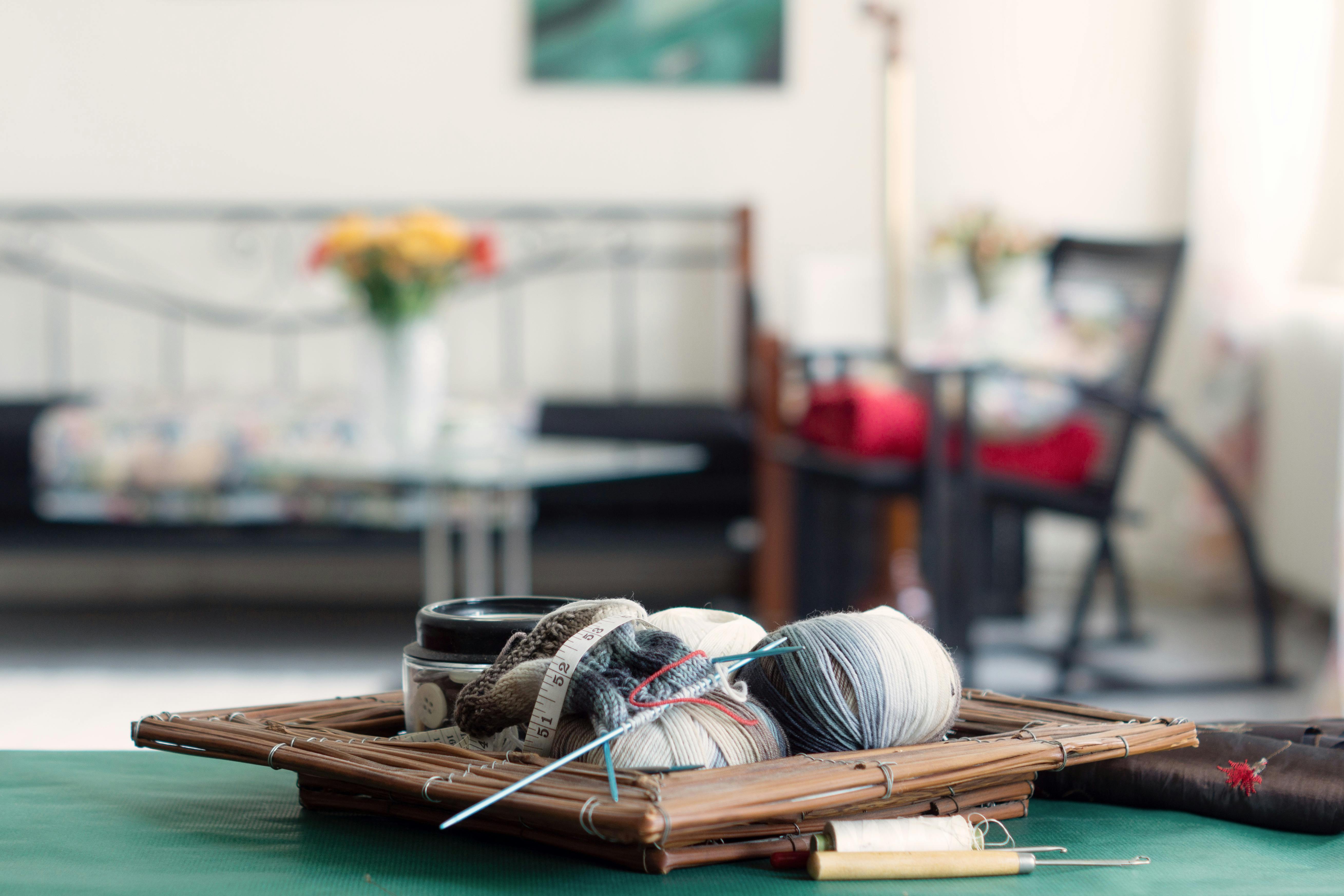 Close-up of knitting essentials on a table, creating a cozy atmosphere indoors for crafting enthusiasts.