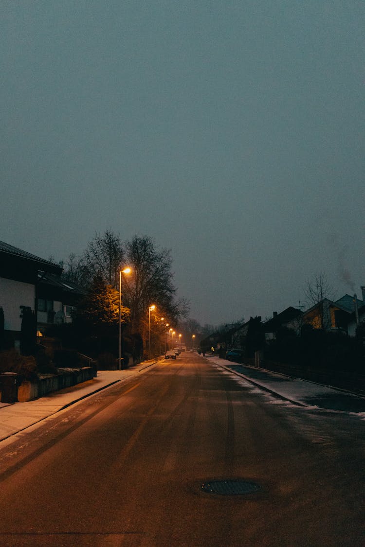 Street Lamps On Road At Night