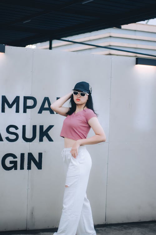 Woman in Pink Shirt and White Jogging Pants