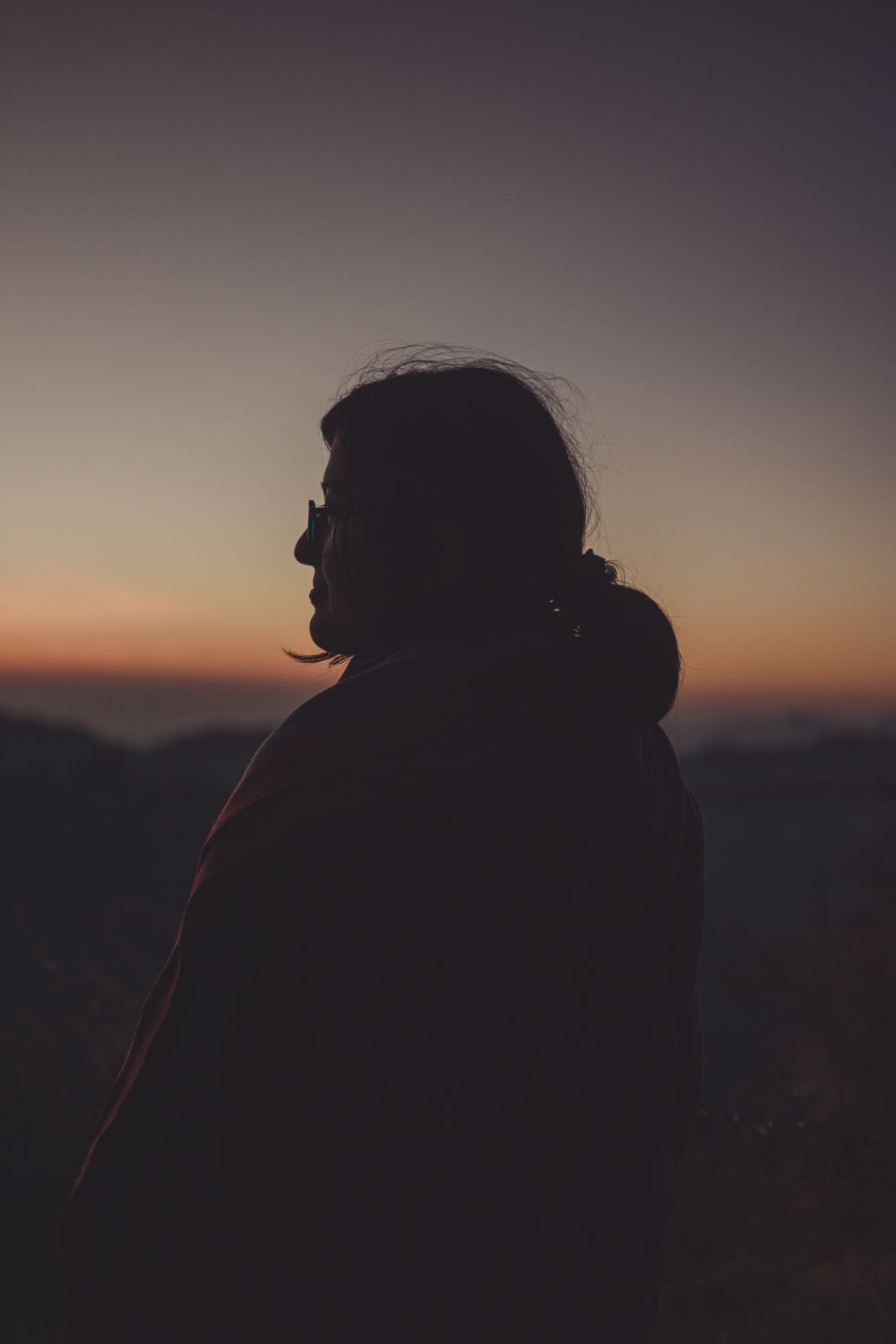 A woman looking out at the sunset · Free Stock Photo
