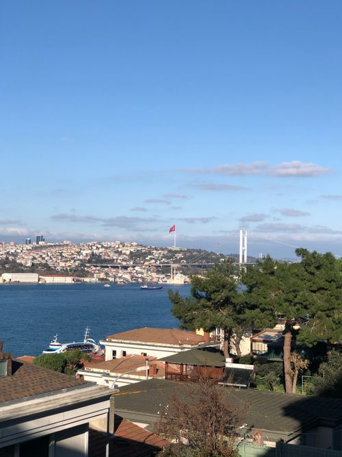 Free Beautiful aerial view of Istanbul with the Bosphorus Bridge and Turkish flag visible, capturing the serene coastal scenery. Stock Photo