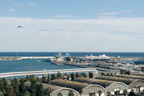 Free Aerial view of the busy port in Barcelona, Spain with ships and clear skies. Stock Photo