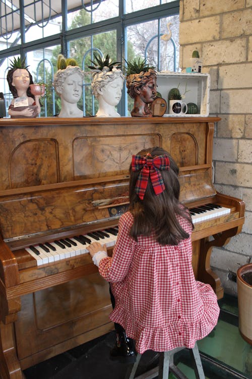 A Girl Playing a Piano 