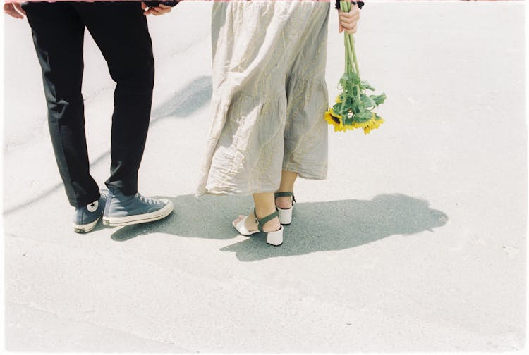 A Couple Walking On The Street