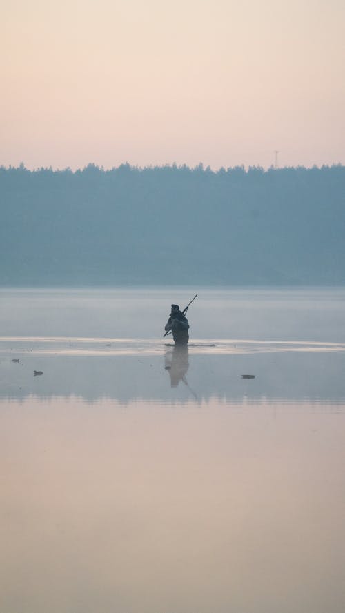 Fisherman in Lake at Dawn