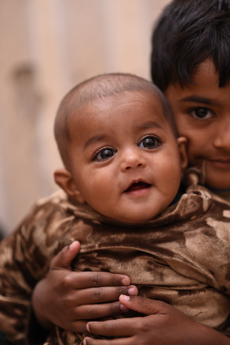 Little Boy Holding His Baby Brother