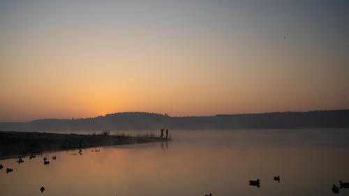 A Hunters at a Foggy Lakeside