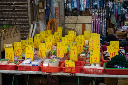 Explore a lively market stall displaying a range of goods with bold sales tags.