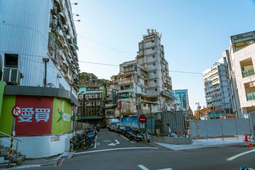 An intersection showcasing old and modern buildings with a vibrant street scene.