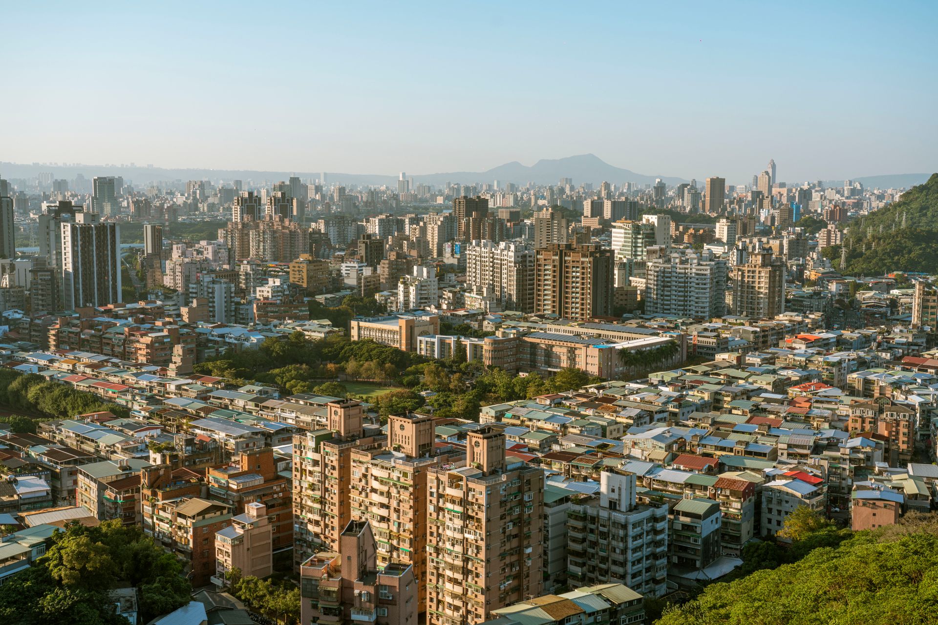 Aerial view of Taipei's bustling city with diverse architecture and sprawling urban landscape.