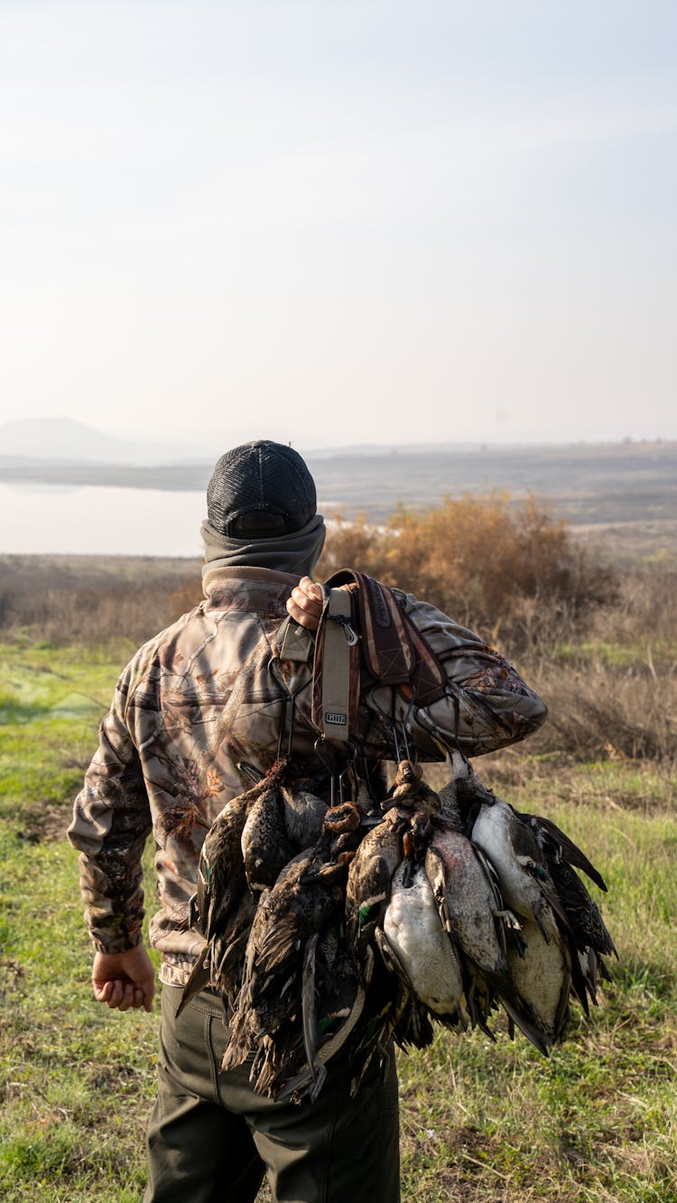 A Hunter Holding Dead Ducks