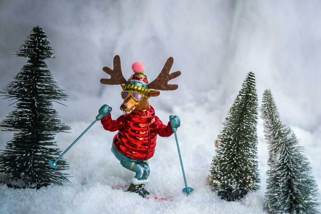 Figurines of Christmas Trees and Skiing Reindeer