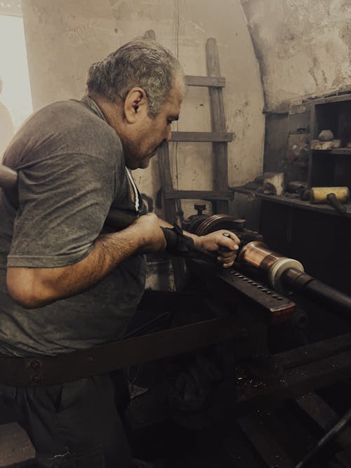 Photo of a Man in a Workshop 