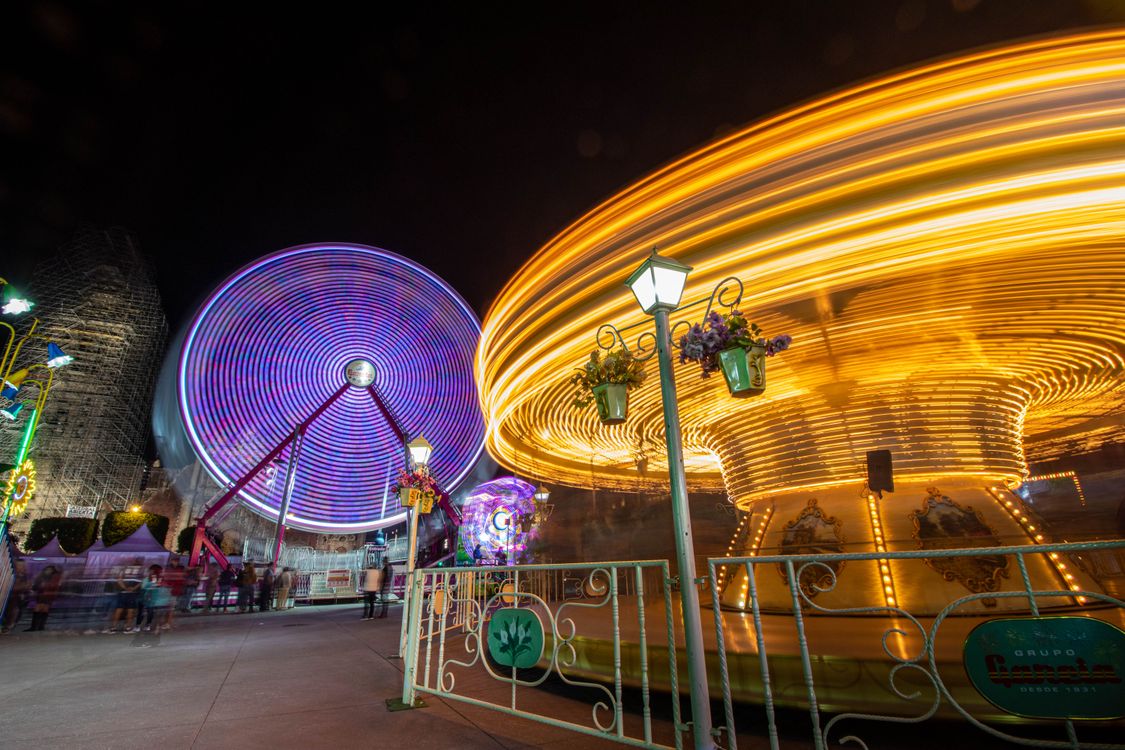Circular Rides Illuminated Carousel and Ferris Wheel at Night · Free Stock Photo