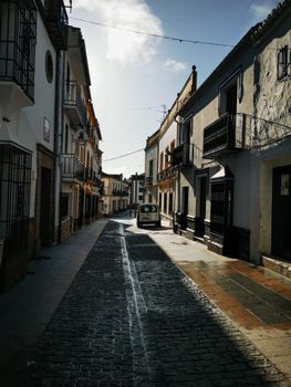 Picturesque view of a narrow cobblestone street lined with historic European buildings.