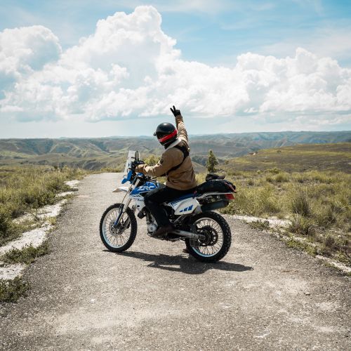 Free Motorcyclist enjoys scenic mountain views on a sunny day. Stock Photo