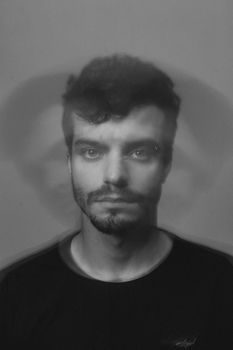 Creative black and white portrait of a man with a blurred effect creating a dynamic artistic look.
