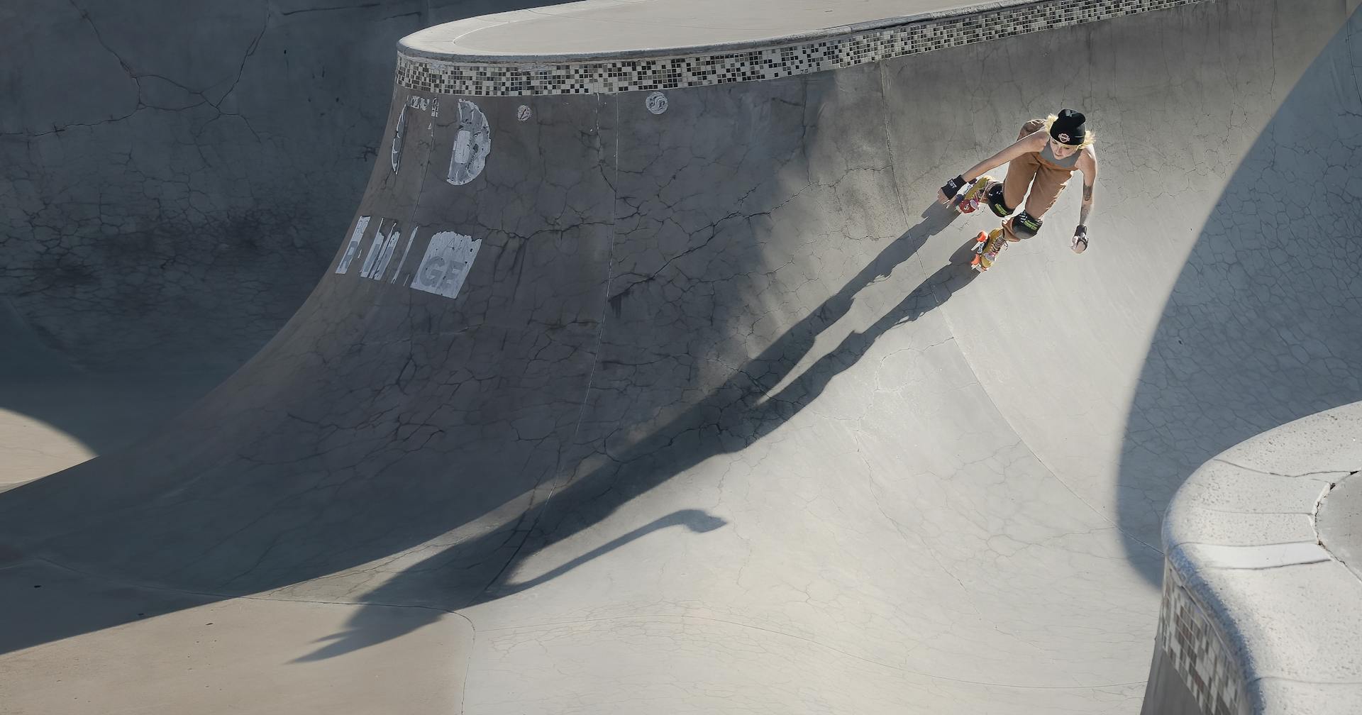 Woman roller skating on a concrete ramp at a skatepark in Colorado Springs, USA.