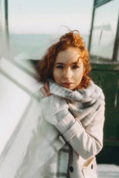 Warm portrait of a red-haired woman wrapped in a scarf on a cold day.