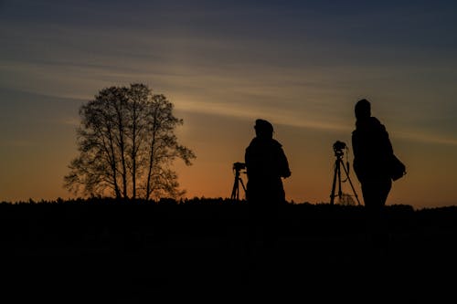 Silhoutte of Two Person Using Camera