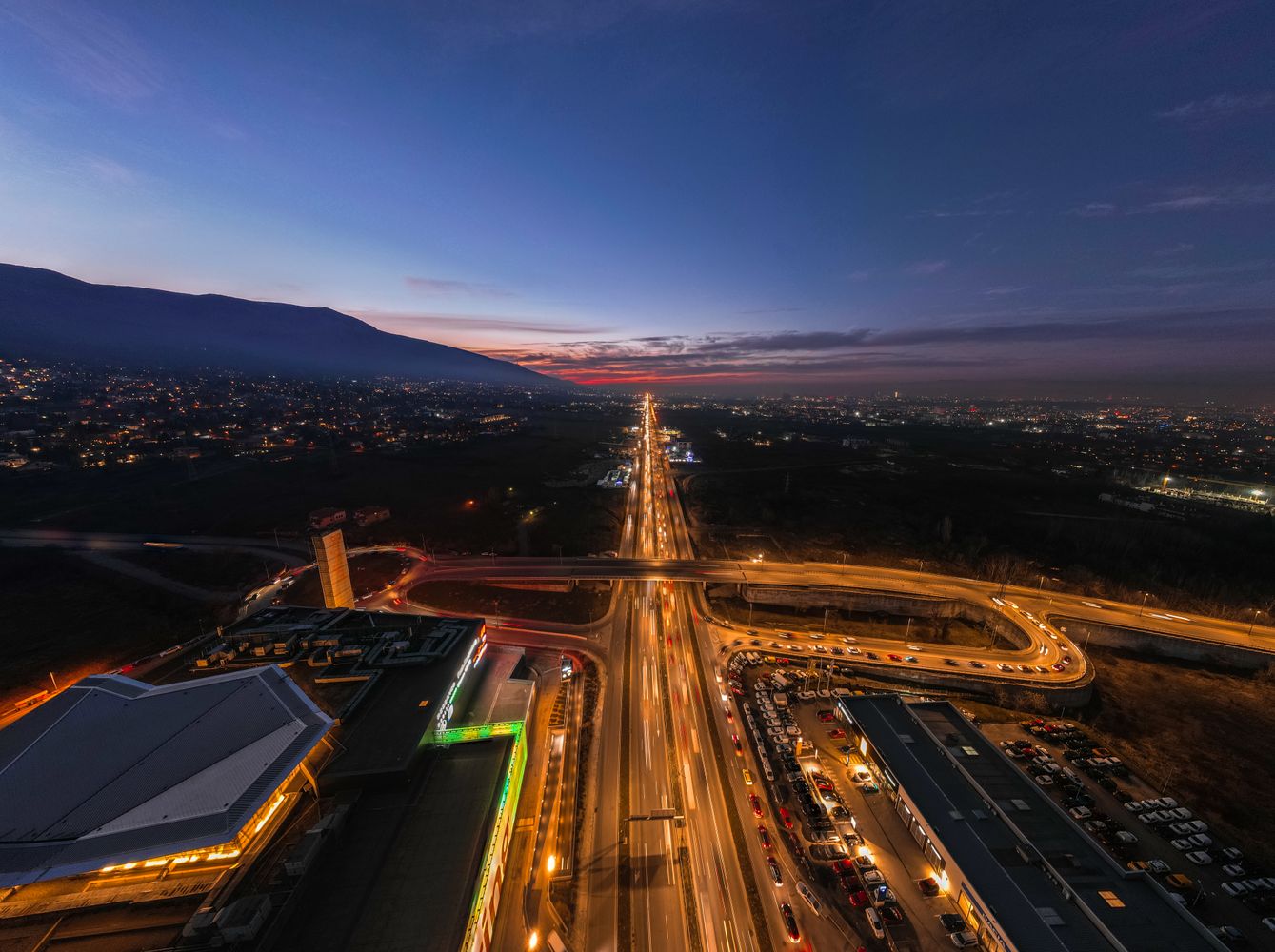 Sunset over Sofia rooftops from a rooftop bar with Vitosha in the distance