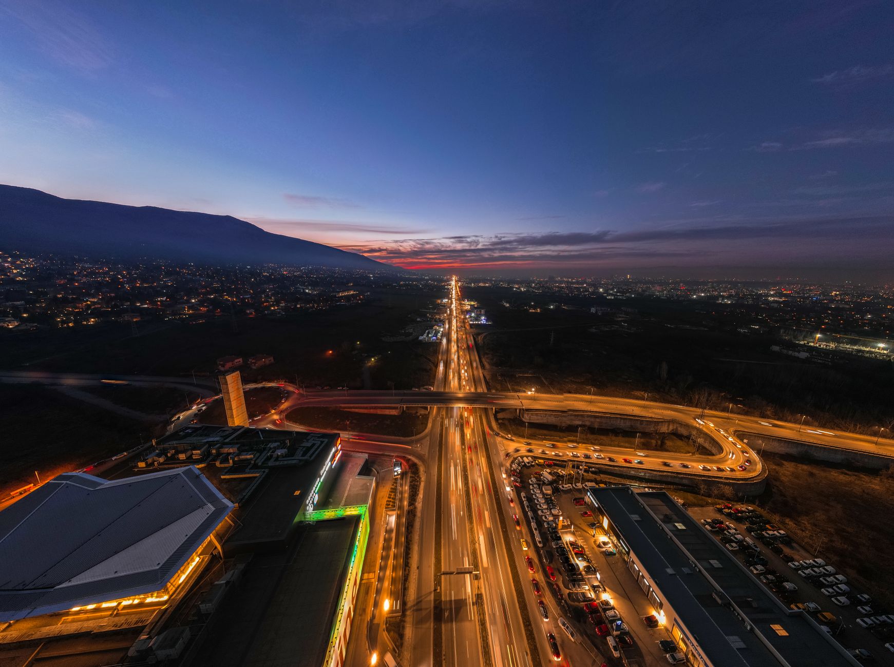 Sunset over Sofia rooftops from a rooftop bar with Vitosha in the distance