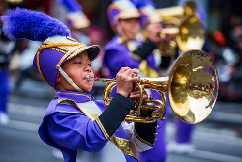 Free A young boy plays the trumpet in traditional clothing during a colorful parade in Taiwan. Stock Photo