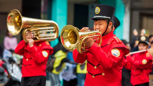 Free Dynamic shot of a marching band playing brass instruments in a parade in Chiayi, Taiwan. Stock Photo
