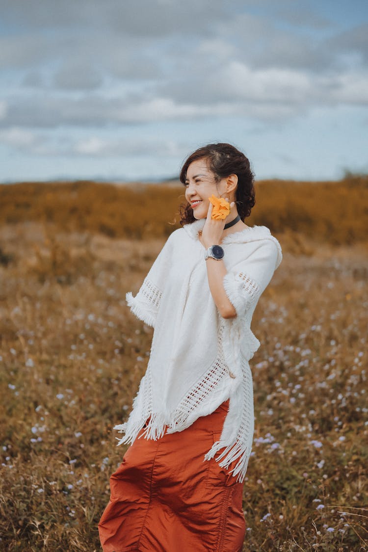 Woman Outdoors On A Field Smiling 