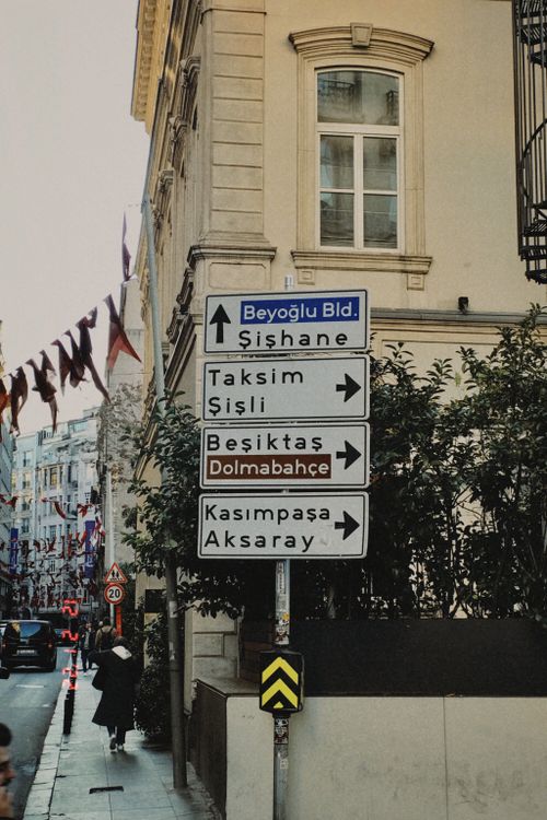 Free Directional signs in Istanbul pointing to local landmarks like Taksim and Beşiktaş. Stock Photo