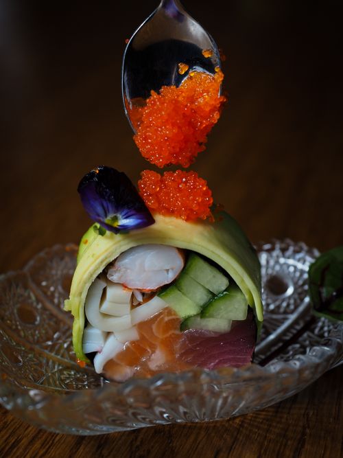 Free A delicious sushi roll with salmon, cucumber, and a caviar garnish. Stock Photo