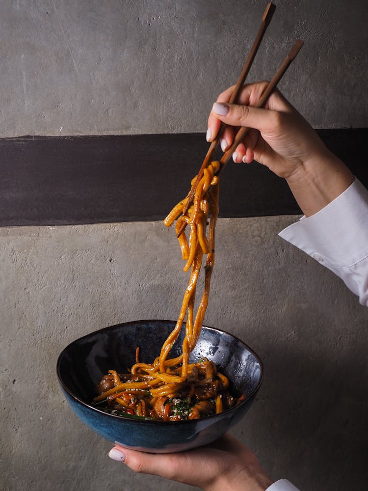 Woman With Bowl Of Noodles