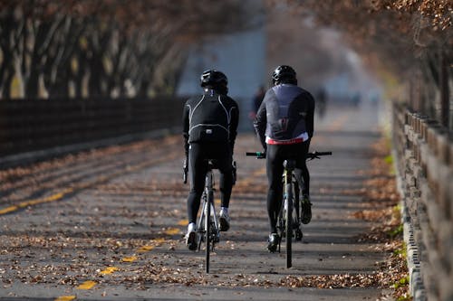 A Pair of Bikers Biking on a Dirty Road