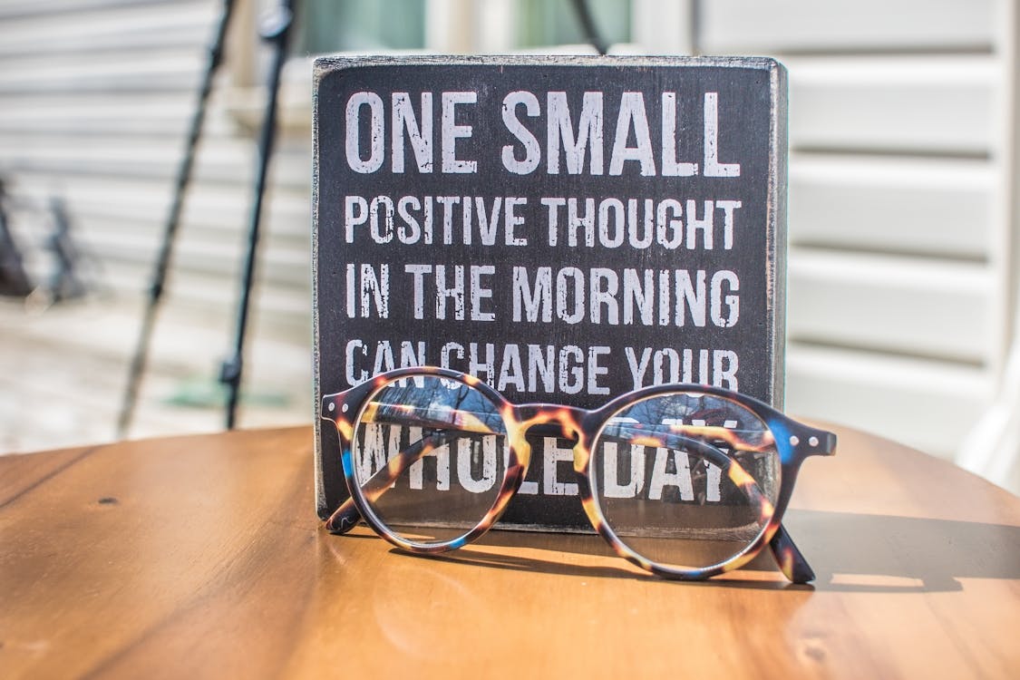 Free Photo of a Sign and Eyeglasses on Table Stock Photo