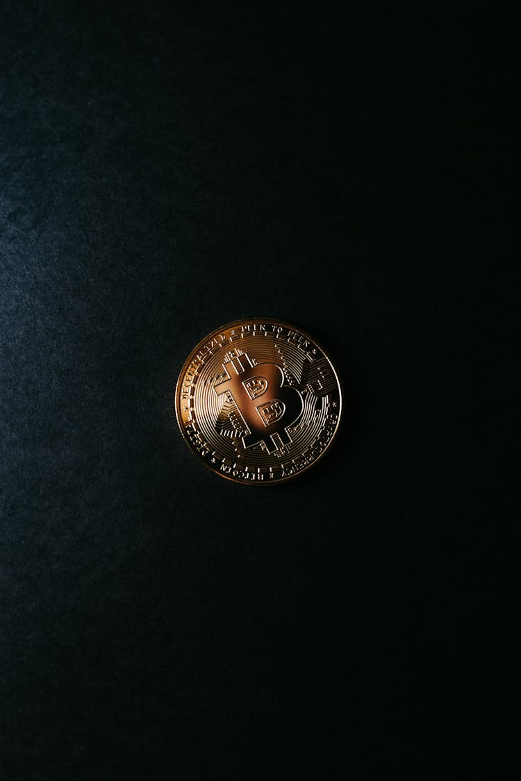 A Coin On A Black Surface