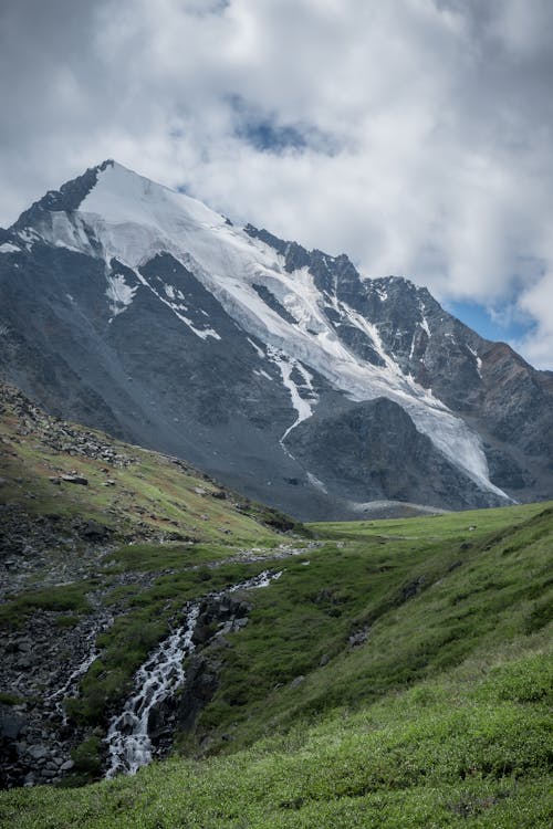 Gray Rock Mountain with Snow near the Green Grass · Free Stock Photo