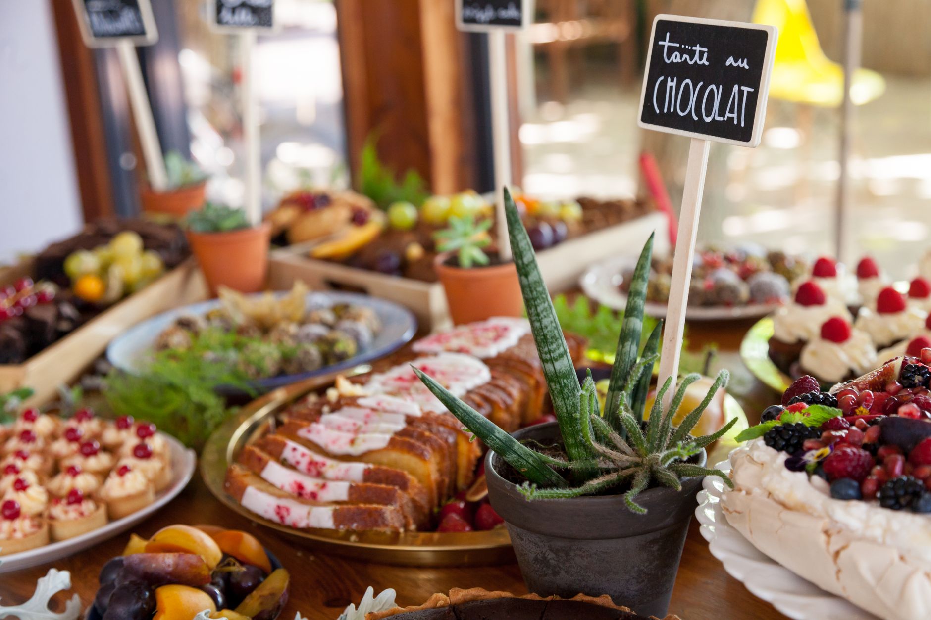 A vibrant spread of assorted pastries and cakes displayed on a dessert table for special occasions.