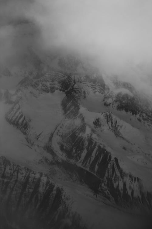 Black and White Photo of a Covered in Snow Mountain 