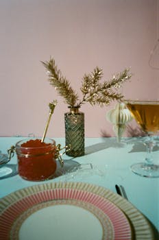 Stylish table setup with gold accents, champagne, and hors d'oeuvres for a festive celebration.