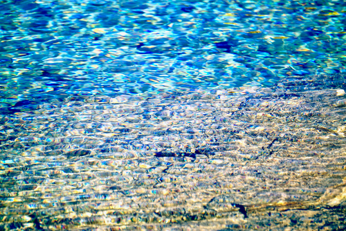 Free Close-up of rippling blue water showcasing vibrant abstract textures and reflections. Stock Photo