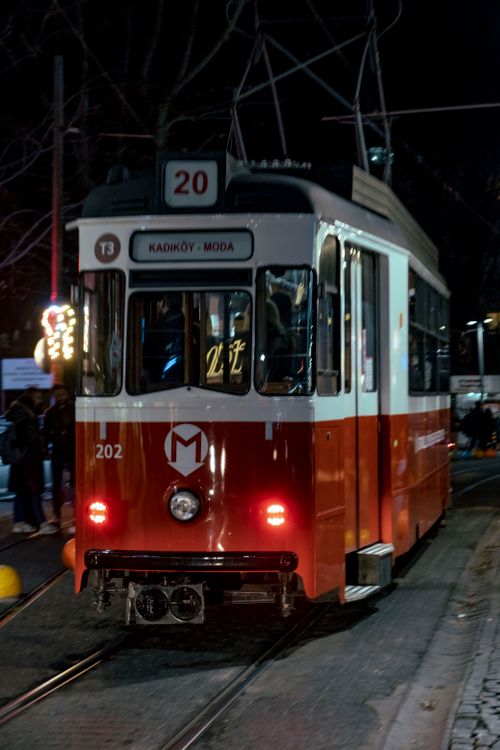 Free Captured at night, a historic tram rides through Istanbul's Kadıköy Moda neighborhood. Stock Photo