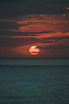 A breathtaking ocean sunset featuring a vivid sky with vibrant hues reflecting on the sea.