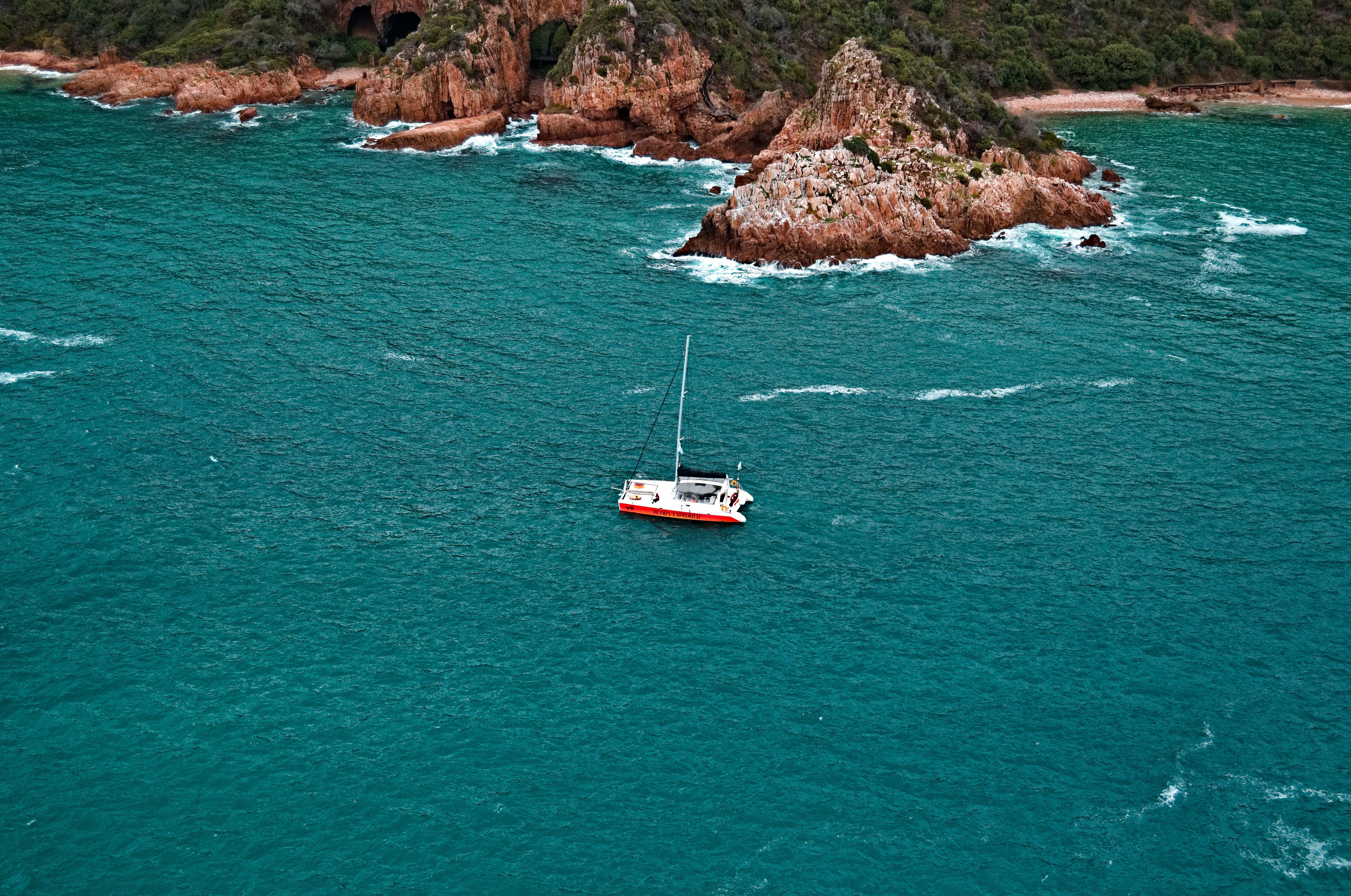 Stunning Daysail-West End to JVD-6hr-Every Wednesday-land & Sea Review: The Ultimate British Virgin Islands Sailing Adventure Review 2026 - Aerial view of a sailboat navigating turquoise waters near a rocky coastline.