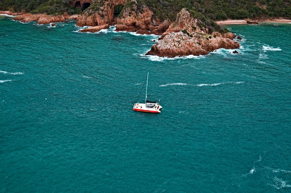 Stunning Daysail-West End to JVD-6hr-Every Wednesday-land & Sea Review: The Ultimate British Virgin Islands Sailing Adventure Review 2026 - Aerial view of a sailboat navigating turquoise waters near a rocky coastline.